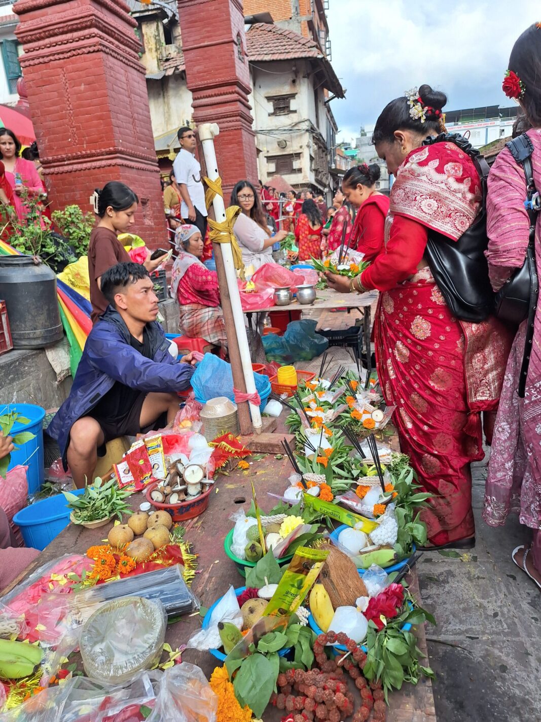 Vendor selling ritual items to devotee in the festival
