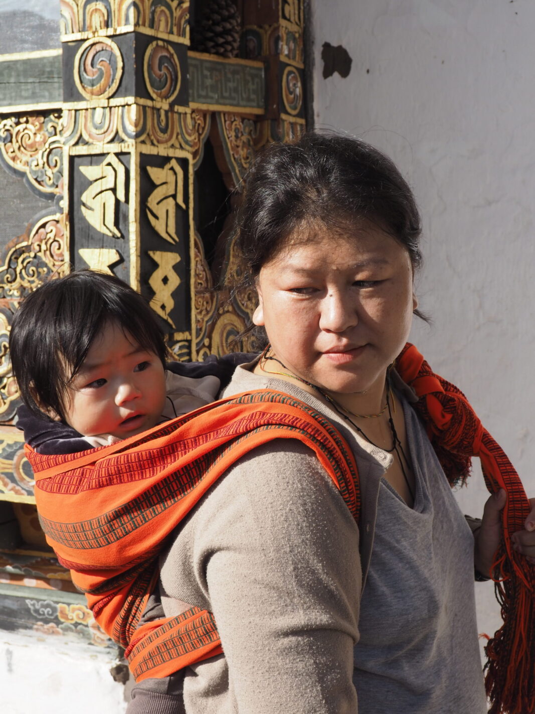 Bhutanese women with her child in back